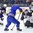 POPRAD, SLOVAKIA - APRIL 22: USAâ€™s Dylan St. Cyr #1 makes a save on Sweden's Isac Lundestrom #20 while Sweden's Emil Bemstrom #16 and USAâ€™s David Farrance #27 look on during semifinal round action at the 2017 IIHF Ice Hockey U18 World Championship. (Photo by Andrea Cardin/HHOF-IIHF Images)